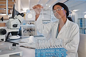 Finding that perfect spot. a young female lab tech analysing a sample in her office.