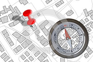 Finding the right building - Solution concept with an imaginary city map and navigational compass photo
