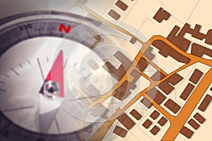Finding the right home for you! - Concept image with a city map, buildings, roads and navigational compass