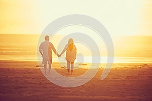 Finding their own paradise. Rearview shot of an affectionate mature couple walking hand in hand on the beach.