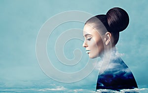 Fine art portrait of perfect woman with blue clouds and sky