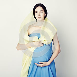 Fine art portrait of young pregnant woman