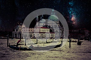 Fine art retro image with gondola on Canal Grande at night with wood planks floor for foreground, full moon and milky, Venice, It