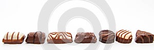 Fine brown white chocolate pralines on a single row