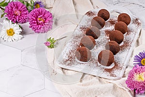 Fine chocolate truffles on white ceramic plate