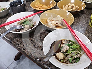 Fine Cut White Rice Noodle Thicken Soup topping Sliced Pork and Pork Ball eat with pork snackThai Crispy wonton food