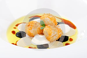 Fine dining, deep fried scallops with olive oil, cheese