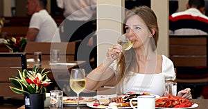 Fine dining food. Young smiling woman in luxury restaurant