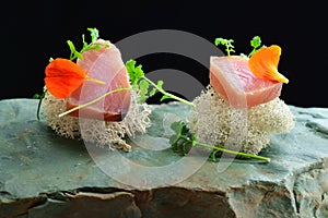 Fine dining, fresh raw ahi tuna sashimi served on an ocean sponge