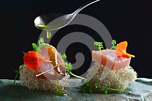 Fine dining, fresh raw ahi tuna sashimi served on an ocean sponge