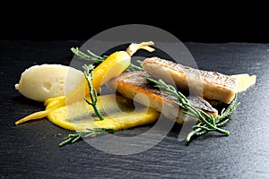 Fine dining Seabass fillets on carrot potato