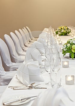 Fine dining table with white linen at a banqueting dinner set up photo