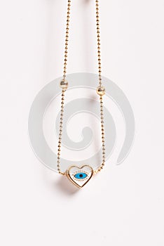 Fine Gold-Tone Chain Necklace with Eye-Inlaid Heart Pendant