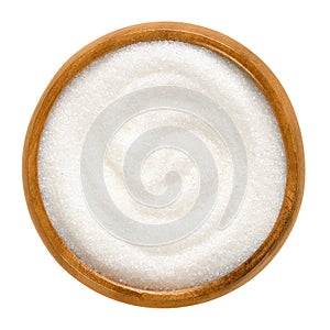 Fine granulated white sugar in wooden bowl over white