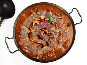 Fine Meat - Wild Game Meat Ragout in a Pan with Cranberries isolated on white Background