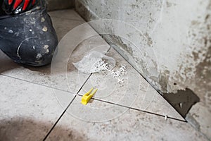 Fine precise accurate work of a tiler when laying tiles on the floor