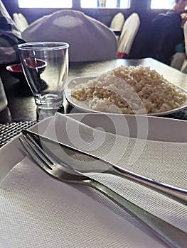 Fine restaurant dinner table place setting and plate with rise