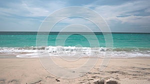 Fine sand of Dreamland beach are washed by the foamy Indian ocean waves