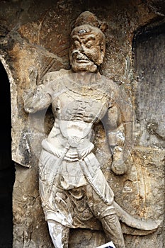 A fine statue of Buddha is carved on a rock