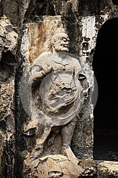 A fine statue of Buddha is carved on a rock