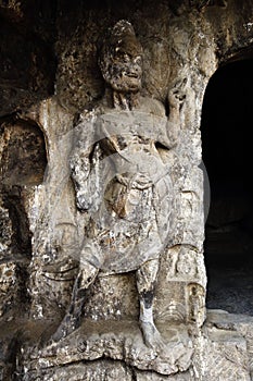 A fine statue of Buddha is carved on a rock