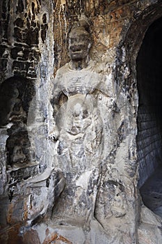 A fine statue of Buddha is carved on a rock