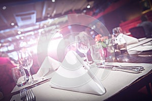 Restaurant table setting with bright light flare