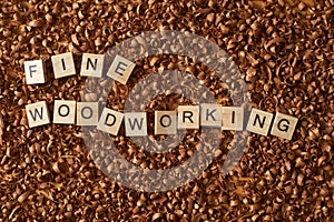 Fine woodworking word writen with letters on a wood chips