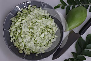 Finely chopped totapuri mangoes rubbed with salt as a preparation for instant mango pickle