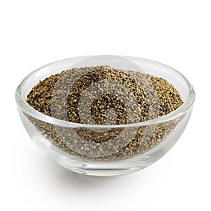 Finely ground black pepper in glass bowl.