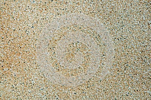 Finely structured sand-colored surface with black dots