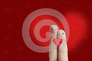 Finger art of a Happy couple. Lovers is embracing and holding red heart. Stock Image