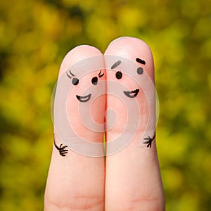 Finger art of a Happy couple. A man and a woman hug on the background of yellow leaves