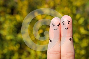 Finger art of a Happy couple. A man and a woman hug on the background of yellow leaves