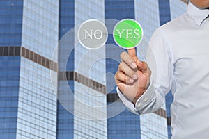 Finger of Businessman touch to green button and text in YES.