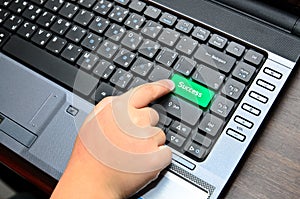 Finger of chind pushing the button of keyboard