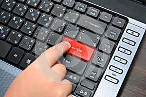 Finger of chind pushing the button of keyboard