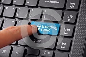 Finger clicking Trending Topic on keyboard