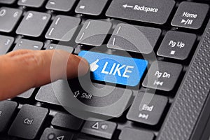 Finger clicks LIKE button