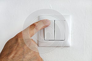 Finger at electric light switch