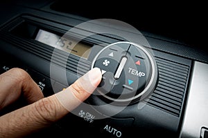 Finger on Fan switch of a Car air conditioning system photo