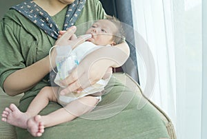 Finger Feeding breast milk to newborn baby boy using small tube