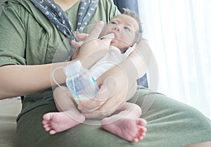 Finger Feeding breast milk to newborn baby boy using small tube