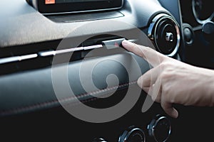 Finger hitting Emergency button in the car