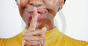 Finger on lips, privacy and woman with secret, whisper or gossip, laughter and silencer on white background. Quiet