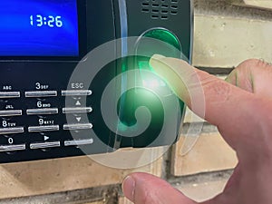 A finger placed on an access control terminal with fingerprint, laser fingerprint reader