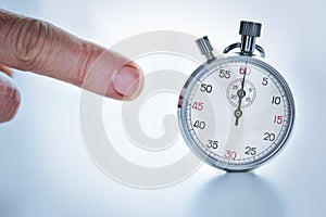 Finger pointing a stopwatch