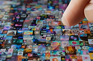 Finger pointing at tablet screen with Beeple pattern EVERYDAYS: THE FIRST 5000 DAYS