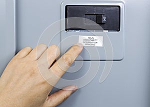 Finger pointing to main circuit breaker