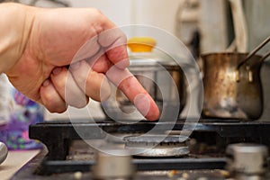 A finger points to a dirty stove